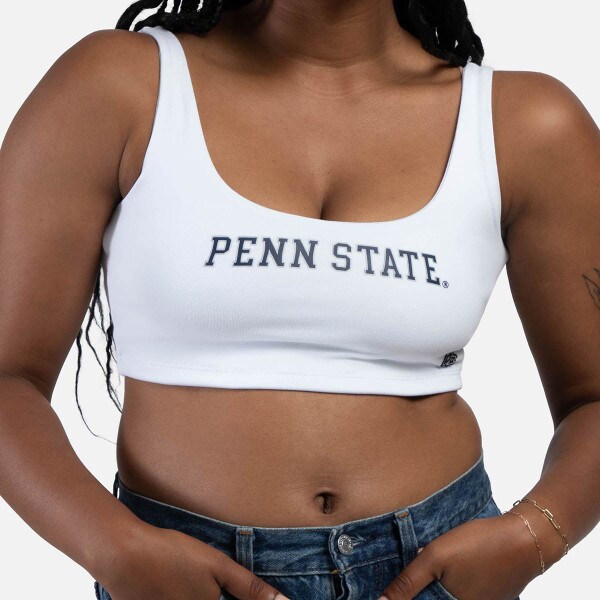 model wearing women's white scoop neck crop top with screened Penn State